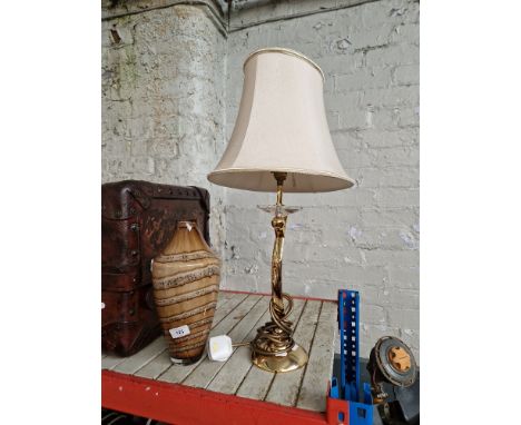 A brass table lamp and a glass vase 