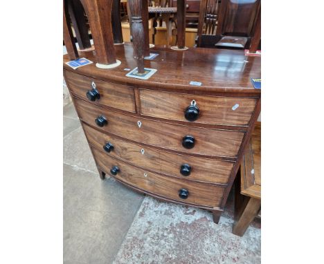 A Regency bow front mahogany chest of drawers standing on splayed bracket feet, inlaid and crossbanded to top, bone escutcheo