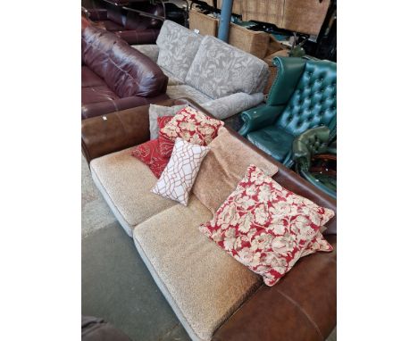 A grey three seater sofa and a brown two seater sofa with various scatter cushions. 