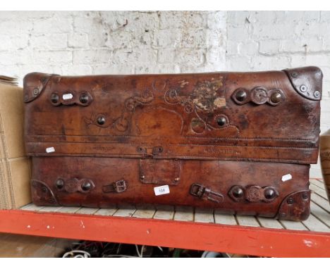 A brown leather travel trunk, circa 1900.
