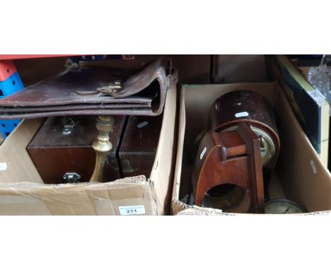 Two wooden boxes, a brass lamp and a leather case.