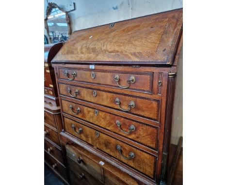 A George III inlaid mahogany bureau with fitted interior, standing on bracket feet and flanked by quarter columns, original g
