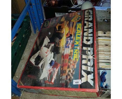 A Scalextric Grand Prix racing game with cars and controllers 