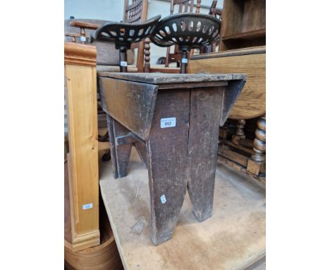 A clogger's stool containing various irons &amp; clogger's tools.