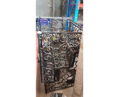 A pair of three step wrought iron garden stands 