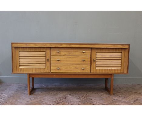 A vintage sideboard with three drawers and two slatted door cupboards