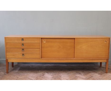 A Robert Heritage Hamilton range light teak sideboard, with four drawers and two sliding doors, with internal shelves and the