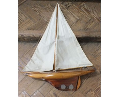 A vintage wooden hull pond yacht