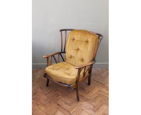 A vintage Ercol armchair with gold upholstery