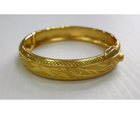 A Chinese 24k yellow gold bangle with embossed decoration, 20.88g, 6 cm diameter, hallmarked, as new