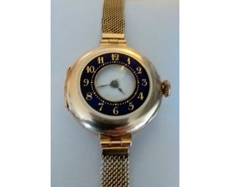 An early 20th century lady's 15ct yellow gold-cased wrist watch with outer blue enamel dial, Arabic numerals, inner dust cove