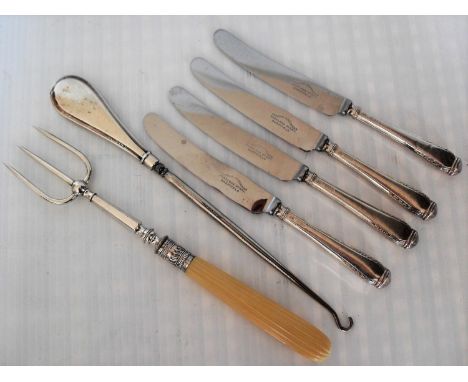 Four silver handles butter knives, a button hook, a silver mounted bread fork and an assortment of silver plated table ware 