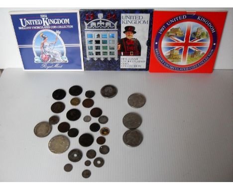 An assortment of coins to include: United Kingdom Uncirculated Coin Collection, 1984, 1994, 1997; Palestine 1927 5 mils, 1935