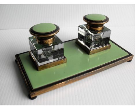 An Art Deco brass and cut-glass double inkwell desk set, 19.5 cm W, minor chips to two bottom corners of one bottle 