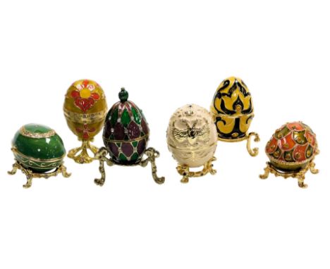 Six Atlas Editions enamel and paste set decorative eggs, with stands, boxed. 