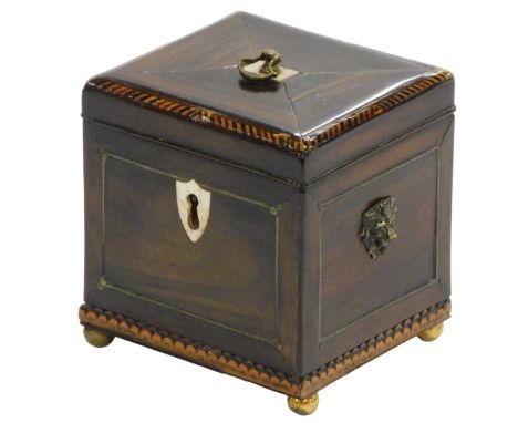A Georgian padouk and cross banded single tea caddy, with bone inlay, brass lion head and ring handles, the lid opening to re