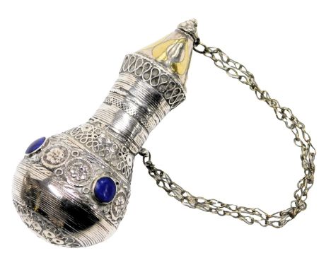 A late 19thC Turkoman powder flask, with embossed floral decoration, and four blue set roundels, white metal, 3.32oz