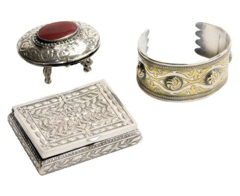 A late 19thC Continental snuff box, with embossed floral and foliate decoration, white metal, 2.28oz, together with an oval b