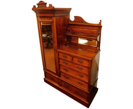 A Victorian walnut compactum, with single wardrobe, with a carved pediment, above a door with rectangular bevelled glass plat