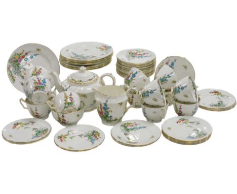 An early 20thC Crown Staffordshire porcelain tea service, printed and painted with hollyhocks and a butterfly, pattern number