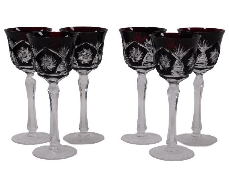 A set of six Bohemian ruby glass wine goblets, with engraved decoration, raised on faceted stems, 20.5cm high. 
