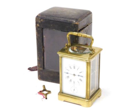 An early 20thC brass cased alarm carriage clock, rectangular dial bearing Roman and Arabic numerals, subsidiary alarm dial, s