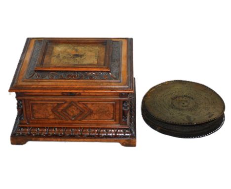 A late 19thC walnut cased polyphon, the lid with marquetry inlay, with a foliate cast surround, the box with panels flanked b