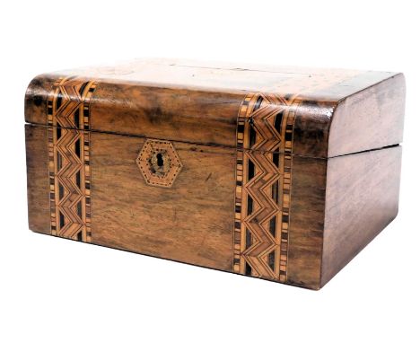 A Victorian walnut and inlaid writing box, the domed lid opening to reveal a dual leather slope and fitted interior, with tra
