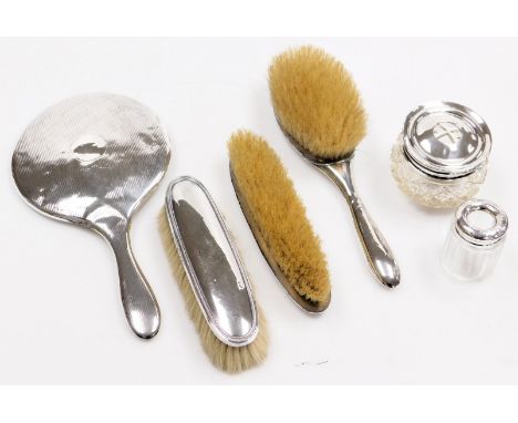 A George V cut glass hair tidy, with silver lid, Birmingham 1912, a silver backed hand mirror with engine turned decoration, 