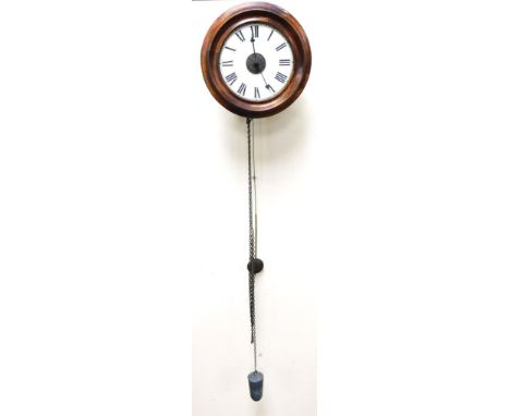 An early 20thC beech cased wall hanging postman's alarm clock, circular dial bearing Roman numerals, centre alarm function, t