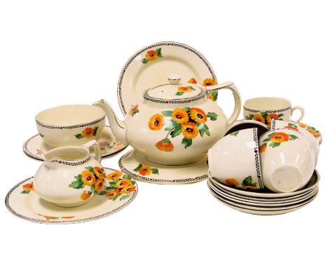 An early 20thC Crown Ducal pottery part tea service, decorated with flowers, comprising teapot, cream jug, sugar bowl, five t