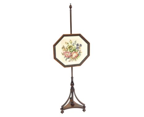 A Regency rosewood pole screen, the octagonal screen with floral woolwork tapestry, raised on a turned column, with outswept 