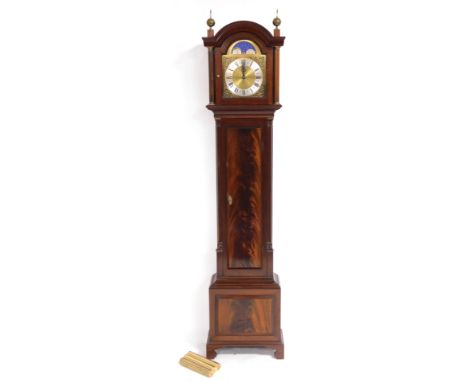 A Georgian style flame mahogany longcase clock, the break arch dial with moon phase, silver chapter ring bearing Roman numera