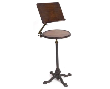 A Victorian walnut, oak and cast iron music stand, by Leveson &amp; Sons, London, the sheet music stand on a brass adjustable