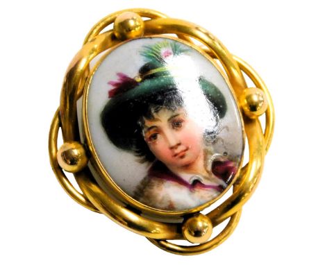 A late 19thC Continental porcelain brooch, painted with a head and shoulders portrait of a boy in a hat, set in yellow metal,