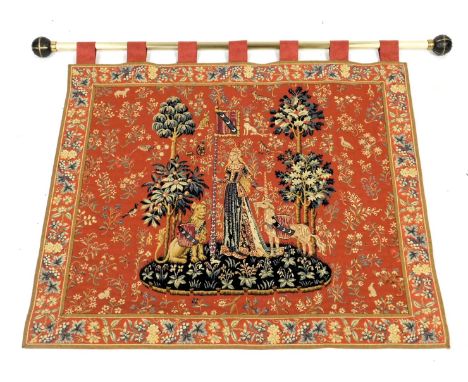 A Tapisserie d'Halluin tapestry, titled Le Toucher, with a brass rail, 80cm x 95cm.