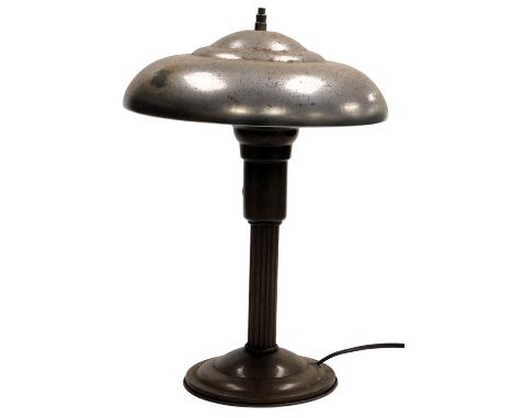 A mid Century industrial tin metal table lamp, with mushroom shaped shade, raised on a fluted brown metal base, 38cm high. Bu