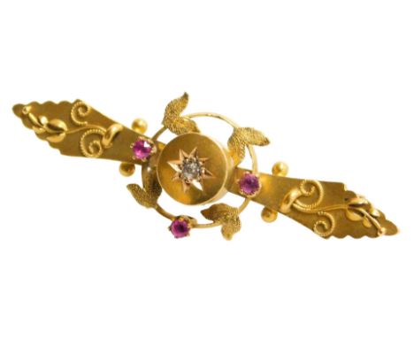 A Victorian 15ct gold, diamond and ruby brooch, the central diamond in a star setting, in a surround of leaves and ruby set b