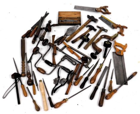An assortment of vintage carpenter's tools, including saws, chisels, files, marking gauge, and braces. (a quantity)
