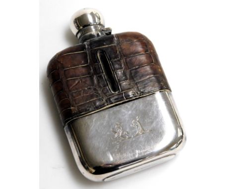 A Victorian leather and silver plated hip flask, with two engraved crests, 15cm high, together with a riding crop brooch. (2)