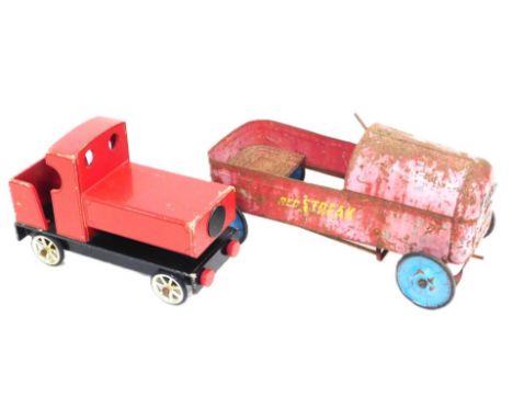 An early 20thC Austin child's pedal car, red painted, 74cm wide, together with a hand built wooden steam train engine, painte