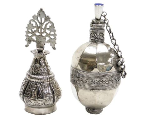 An early 20thC Turkoman scent bottle, with stopper and chain, the finial and base set with blue, white metal, together with a