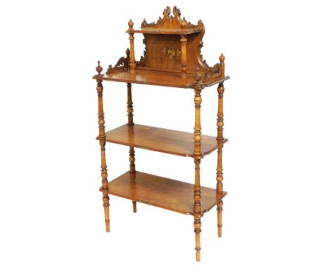 A 19thC French mahogany etagere, the top with a foliate carved three sided gallery, and short shelf raised on turned supports