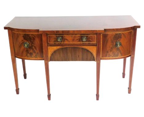 An Edwardian mahogany breakfront sideboard, with shell paterae and boxwood line inlay, the central frieze drawer above a furt