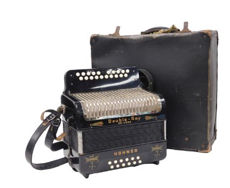 A Hohner Double-Ray Deluxe accordian, with a case.