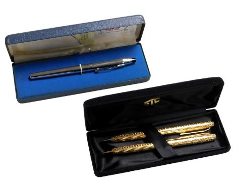 A Taylor gilt metal pen and propelling pencil set, together with a Cross rollerball pen. (2) 