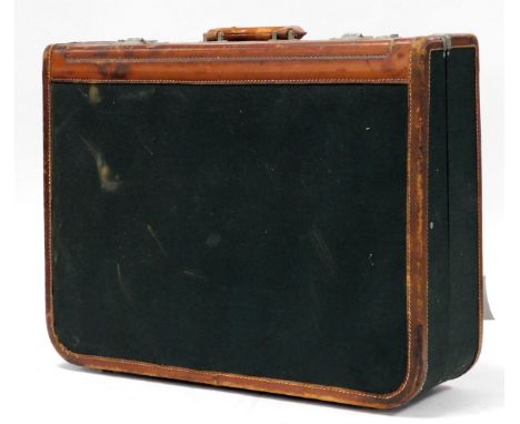A vintage tan leather and green canvas suitcase, 62cm wide.