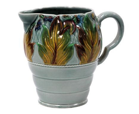 A Clarice Cliff pottery jug, moulded with a band of leaves and berries, on a celadon ground, printed marks, 20cm high.