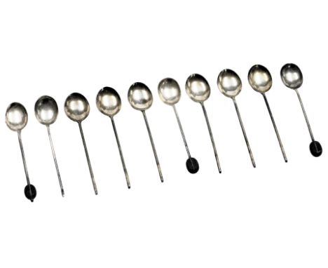 A set of six George V silver and guilloche enamel coffee spoons, bean terminals lacking, Birmingham 1929, and four further co