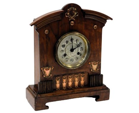A late 19thC Art Nouveau wooden cased mantel clock, circular silvered dial bearing Arabic numerals, eight day movement with b